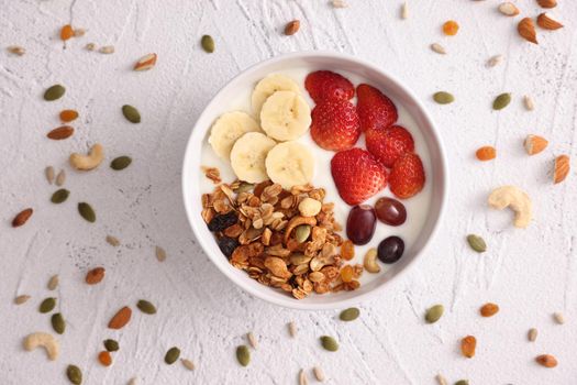 bowl of granola cereal with yogurt and berries isolated on white background