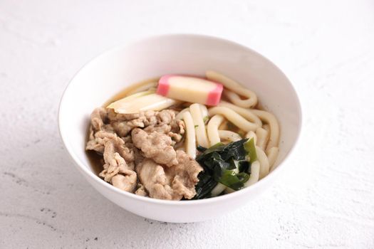 Udon noodles with pork isolated in white background