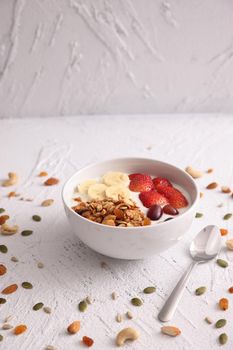 bowl of granola cereal with yogurt and berries isolated on white background
