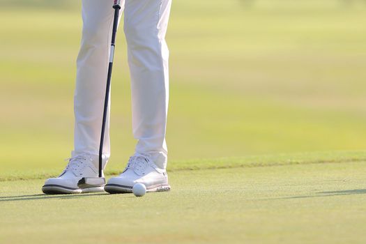 Young male golfer player on golf course