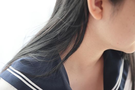 Close up of Asian High School Girl shoulder in white room