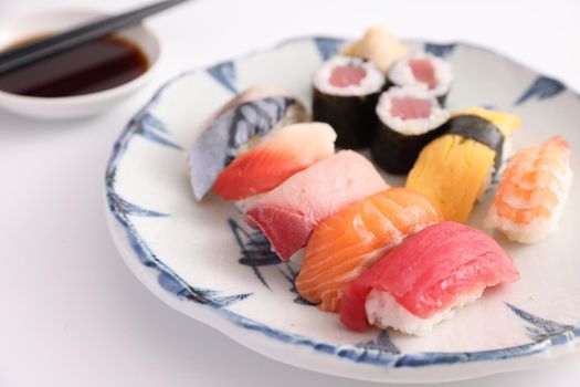 Sushi Set nigiri and sushi rolls with soy sauce and chopsticks Japanese food isolated in white background