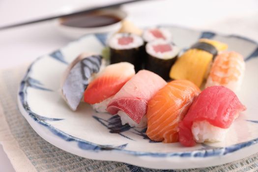 Sushi Set nigiri and sushi rolls with soy sauce and chopsticks Japanese food isolated in white background