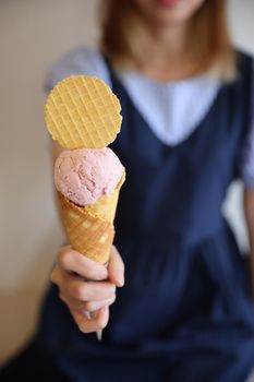 Young woman hand with holding ice cream cone