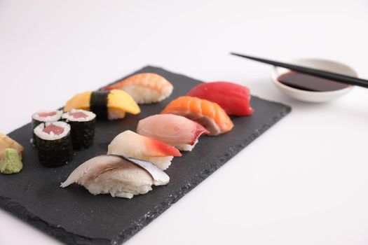 Sushi Set nigiri and sushi rolls with soy sauce and chopsticks Japanese food isolated in white background