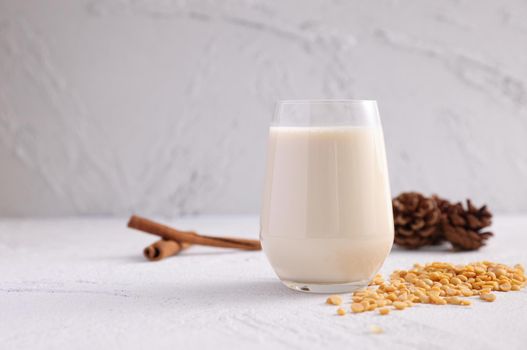 Soy milk in glass and soy bean isolated in white background