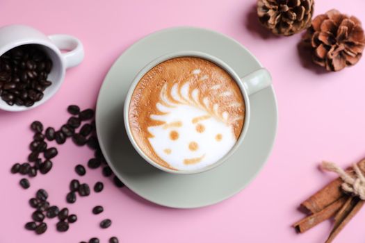 hot cappuccino with latte art isolated in pink background