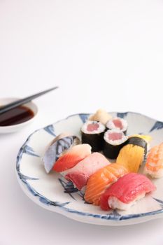 Sushi Set nigiri and sushi rolls with soy sauce and chopsticks Japanese food isolated in white background