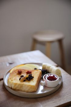 Toast breakfast with dried berry and jam on wood background