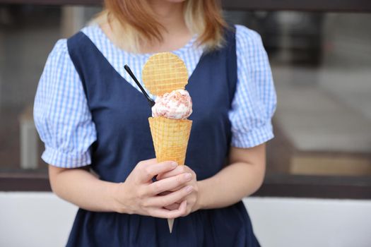 Young woman hand with holding ice cream cone