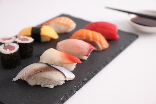 Sushi Set nigiri and sushi rolls with soy sauce and chopsticks Japanese food isolated in white background