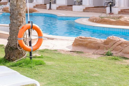 lifebuoy on the fence, by the pool on vacation at the hotel.