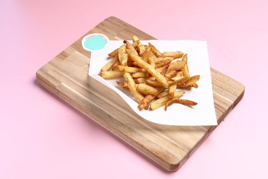 Homemade French fries on rustic wooden table