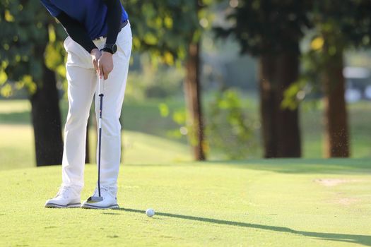 Young male golfer player on golf course