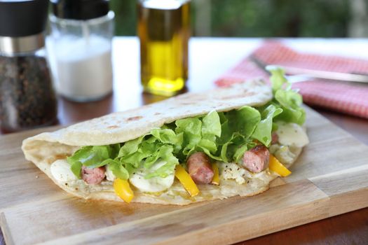 Italian cuisine , Piadina with sausage and cheese