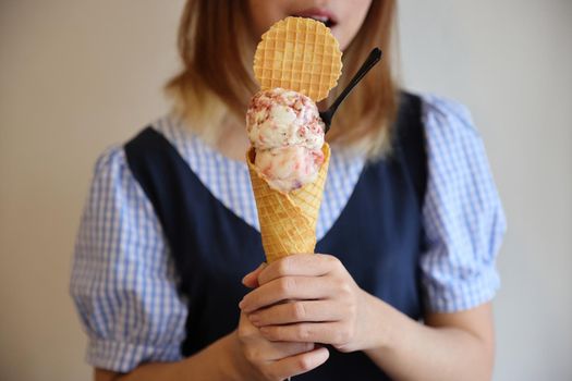 Young woman hand with holding ice cream cone