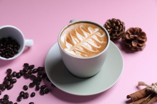 hot cappuccino with latte art isolated in pink background