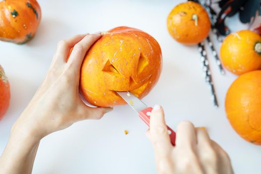 Halloween October 31st. The step-by-step process of carving a pumpkin. View from above