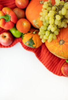 Thanksgiving Day. Autumn harvest pear, apples, pumpkin, pepper, tomato on a white background and red cloth