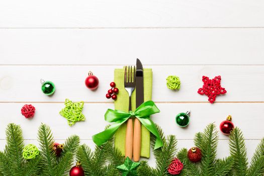 Top view of festive cutlery on new year wooden background. Christmas decorations with empty space for your design. Holiday dinner concept.
