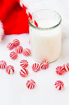 Glass of milk in a jar with a red straw.