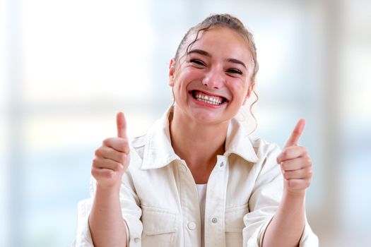 Horizontal shot of a Woman expressing her joy by keeping her thumbs up
