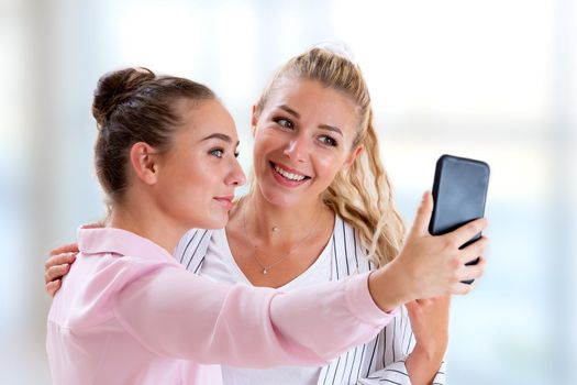Two girlfriends posing for a selfie