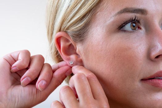 pretty youngwoman hanging an earring