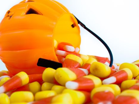 Candy corn candies falling out of Halloween treat bag.