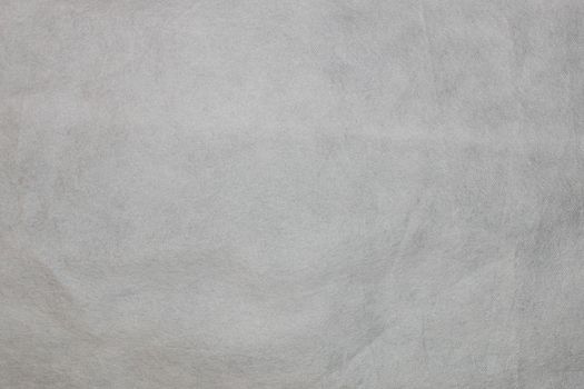 Texture of non-woven material in gray. Background for copy spaced designs. White non-woven fabric as a background texture.