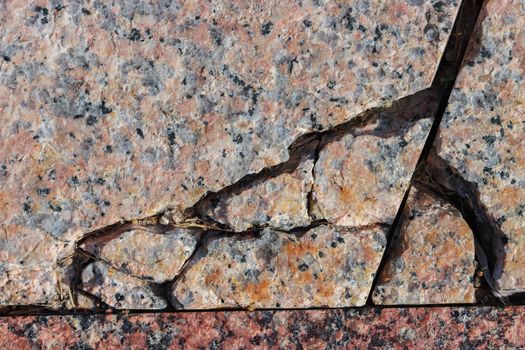 Abstract background of damaged stone floor with cracks.