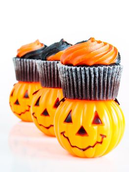 Halloween cupcakes decorated with black and orange swirled icing.