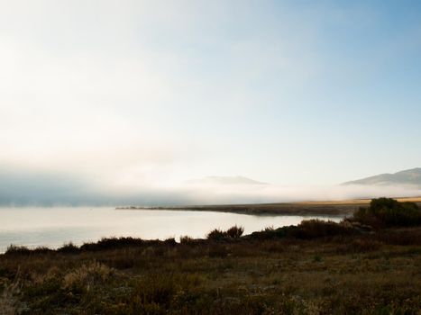 Early morning at the lake with fog in early Fall.