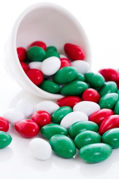 Colorful red, green and white candies on white background.