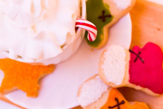 Colorful Christmas sugar cookies with hot chocolate.