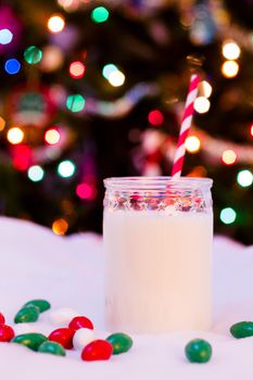 Glass of milk in a jar with a red straw.
