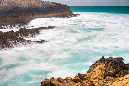 Atlantic ocean. Stormy summer day Big sea wave on rocky beach. Beaty in nature. Dramatic sea view. Long exposure