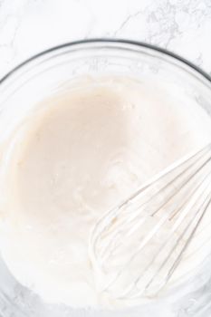 Mixing ingredients into the batter for lemon pound cake.