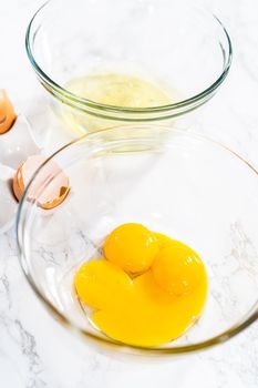 Separating egg whites and yolks to bake meringue cookies.