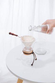 Pouring Water to the Coffee Pot on White Wall and White Table, Manual Brew, Hand Drip Coffee