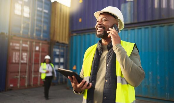 Logistics, shipping and construction worker on the phone with tablet in shipyard. Transportation engineer on smartphone in delivery, freight and international distribution business in container yard.