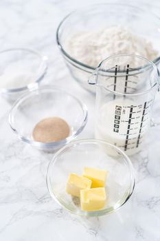 Ingredients for baking brioche buns on the kitchen table.