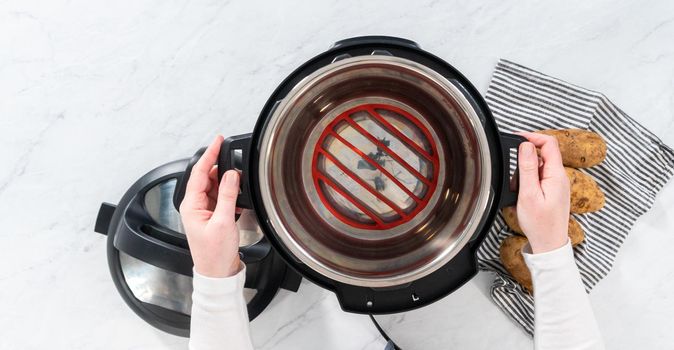 Flat lay. Pressure Cooker Baked Potatoes. Cooking whole potatoes in a pressure cooker to make baked potatoes.