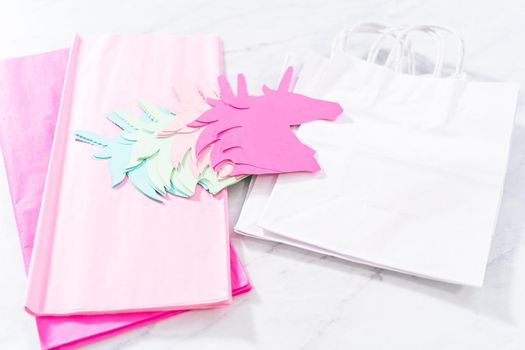 Materials to make unicorn Birthday party favor bags for a little girl's Birthday party.
