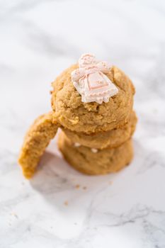 Eggnog cookies with a chocolate gingerbread man in a stack.