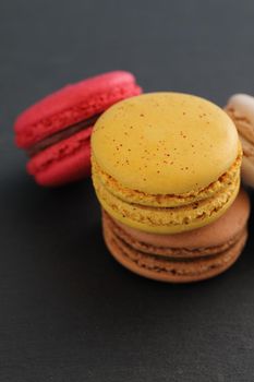 Colorful macarons isolated in black background