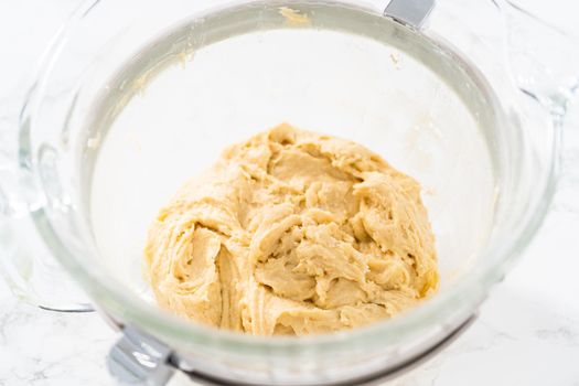 Mixing ingredients in kitchen electric mixer to bake American flag mini cupcakes.