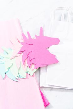 Materials to make unicorn Birthday party favor bags for a little girl's Birthday party.