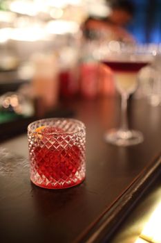 cocktails in glasses on bar counter in pup or restaurant