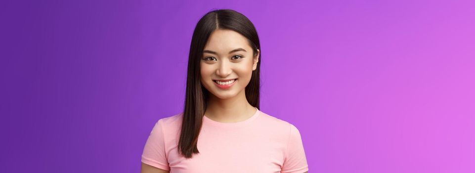 Close-up motivated assertive good-looking asian woman smiling toothy white perfect grin, stand casually have pleasant conversation, talking upbeat, have exciting positive mood purple background.